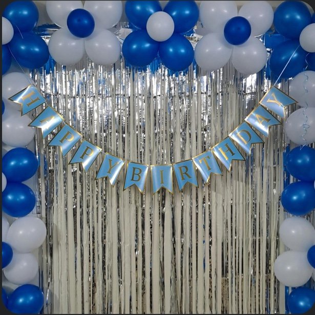 Festive social birthday backdrop setup with metallic streamers and balloons