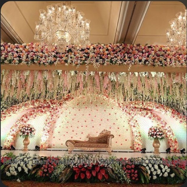 Grand floral Indian wedding mandap stage with chandeliers