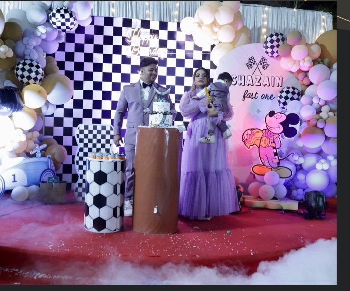 Themed milestone birthday celebration setup with custom backdrops