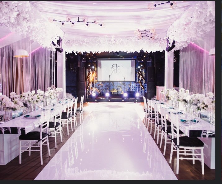 Opulent white floral royal wedding aisle